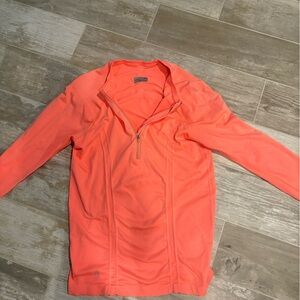 Athleta Orange long sleeved quarter zip running shirt.